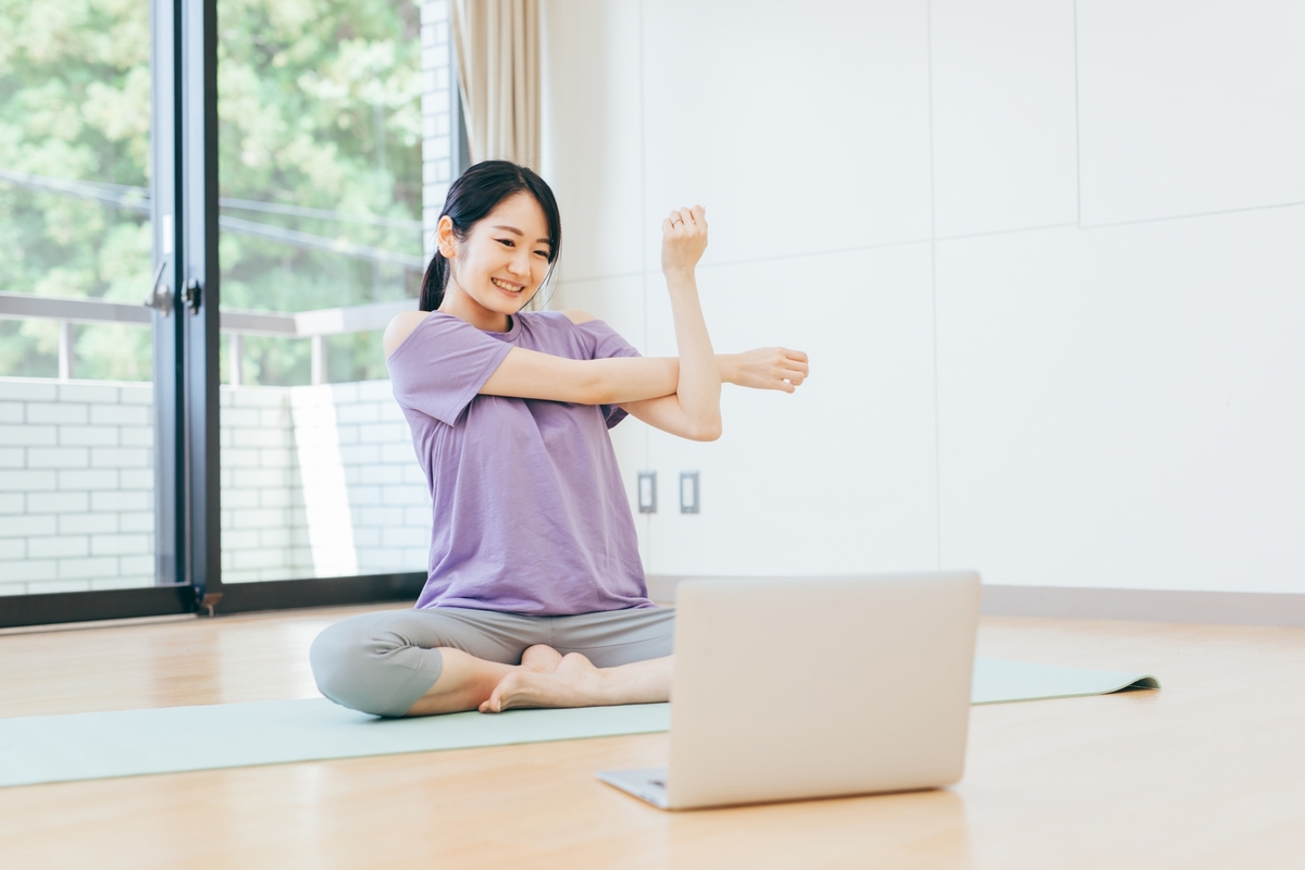 肩をストレッチする女性